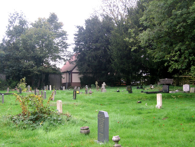 St. Catherine's Churchyard, Cossall (Notts), - Private Kitchen's grave is on the left, partly obscured by the shrub