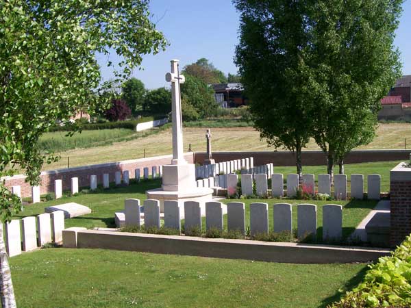 Fricourt British Cemetery. To the rear is the memorial to the men of the Yorkshire Regiment.