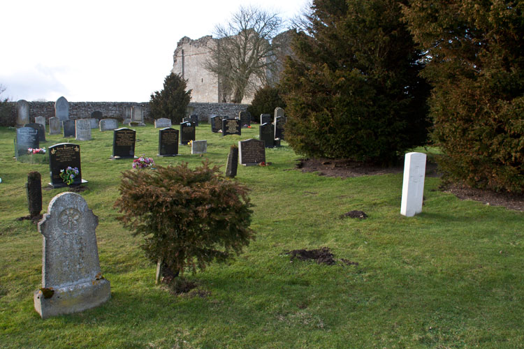 Private Vickers' headstone (white) in the cemetery, with Bowes Castle seen in the background. 