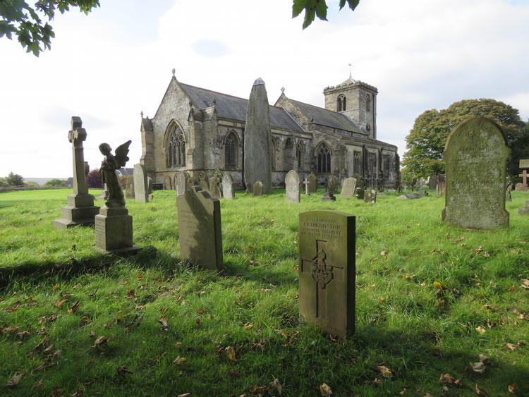 Rudston (All Saints') Churchyard and L/Cpl Etherington's Headstone (also in view is the Rudston Monolith)