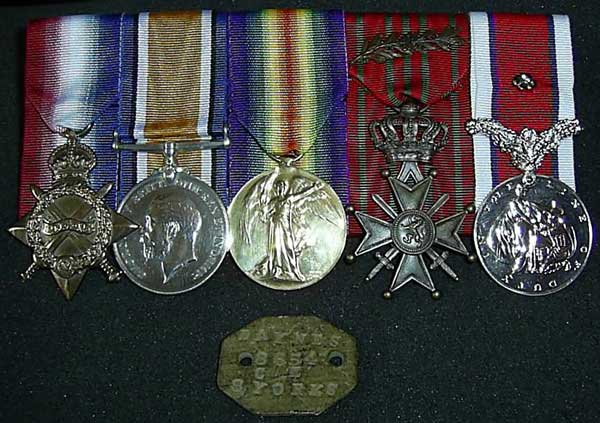 James Daynes medals and identification tag. From the left, the 1914-15 Star, the British War Medal, the Victory Medal and two other medals which are currently not identified.