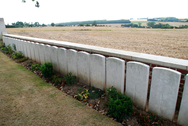 Dantzig Alley British Cemetery, - headstones under a boundary wall. Many of these are for Yorkshire Regiment soldiers.