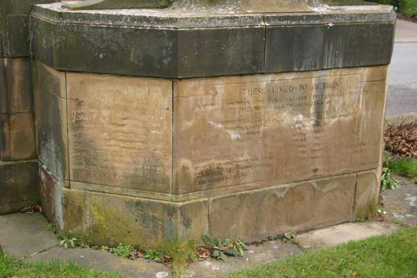 The severely weathered faces of the War Memorial at East Rounton.