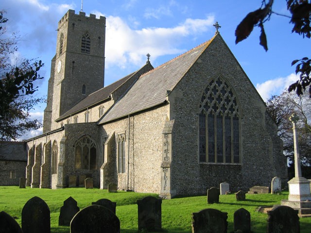 Hindringham War Memorial in the churchyard of St Martin's Church, on the right in this photo.