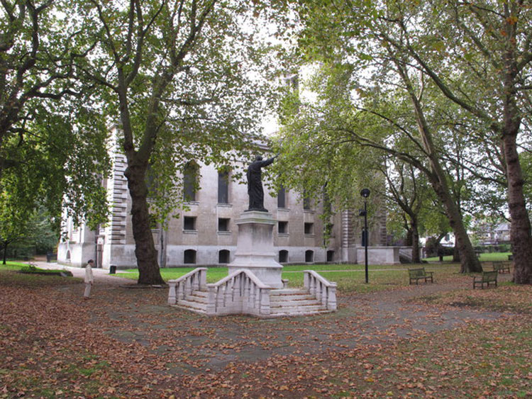 The First World War Memorial outside the Church of St. Anne, Limehouse (London), - with the church itself in the background.
